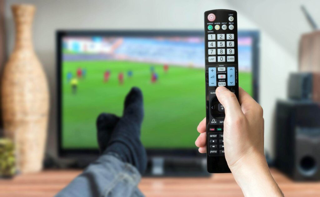 Enjoying Live Soccer Action: An image capturing the excitement as someone watches a live football match, showcasing the immersive sports experience available through TVCrafter's IPTV service