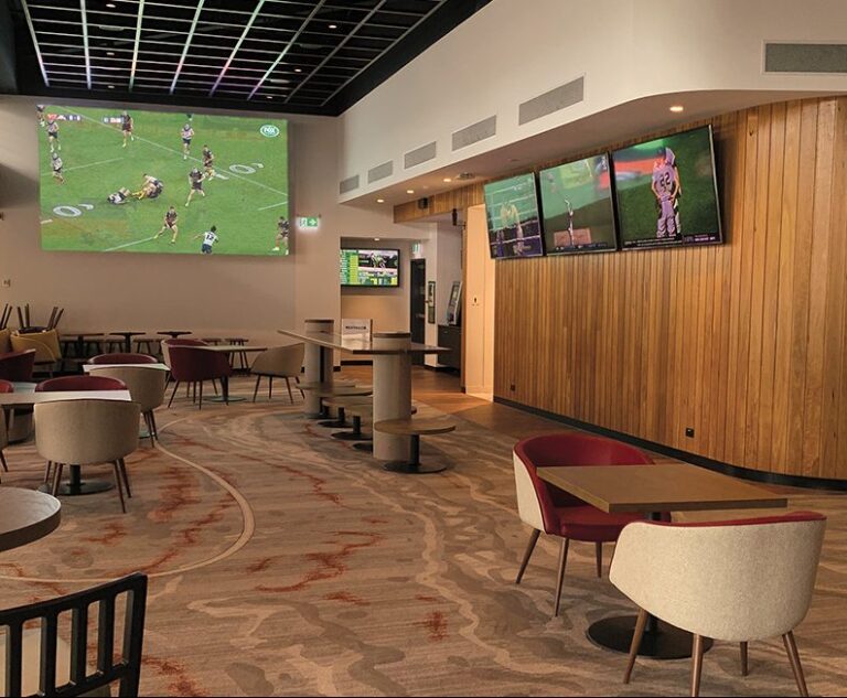 restaurant interior with a television displaying various IPTV channels, symbolizing the IPTV system for revolutionizing the restaurant and café industry provided by TVCrafter