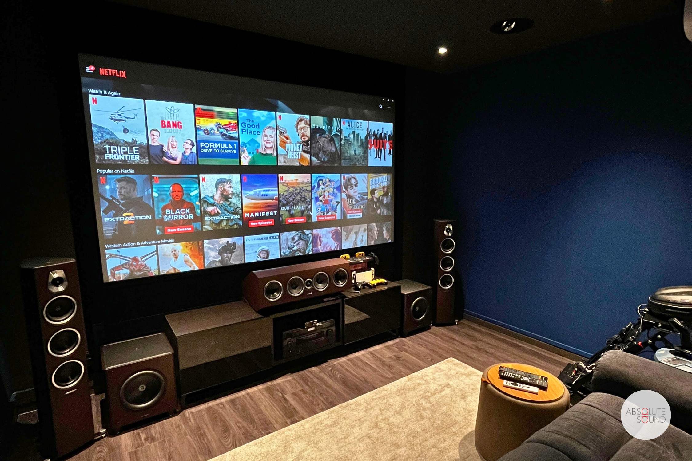 TV setup featuring a home theater 5.1 Dolby Atmos system with front, center, surround speakers, subwoofer, and height channels for immersive audio experience